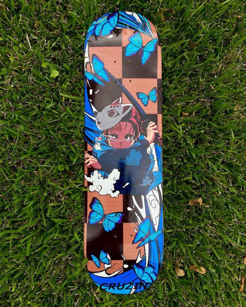 Skateboard wall art anime design featuring a bold character illustration with vibrant blue butterflies on a checkered background, ideal for a girl's bedroom decor.
