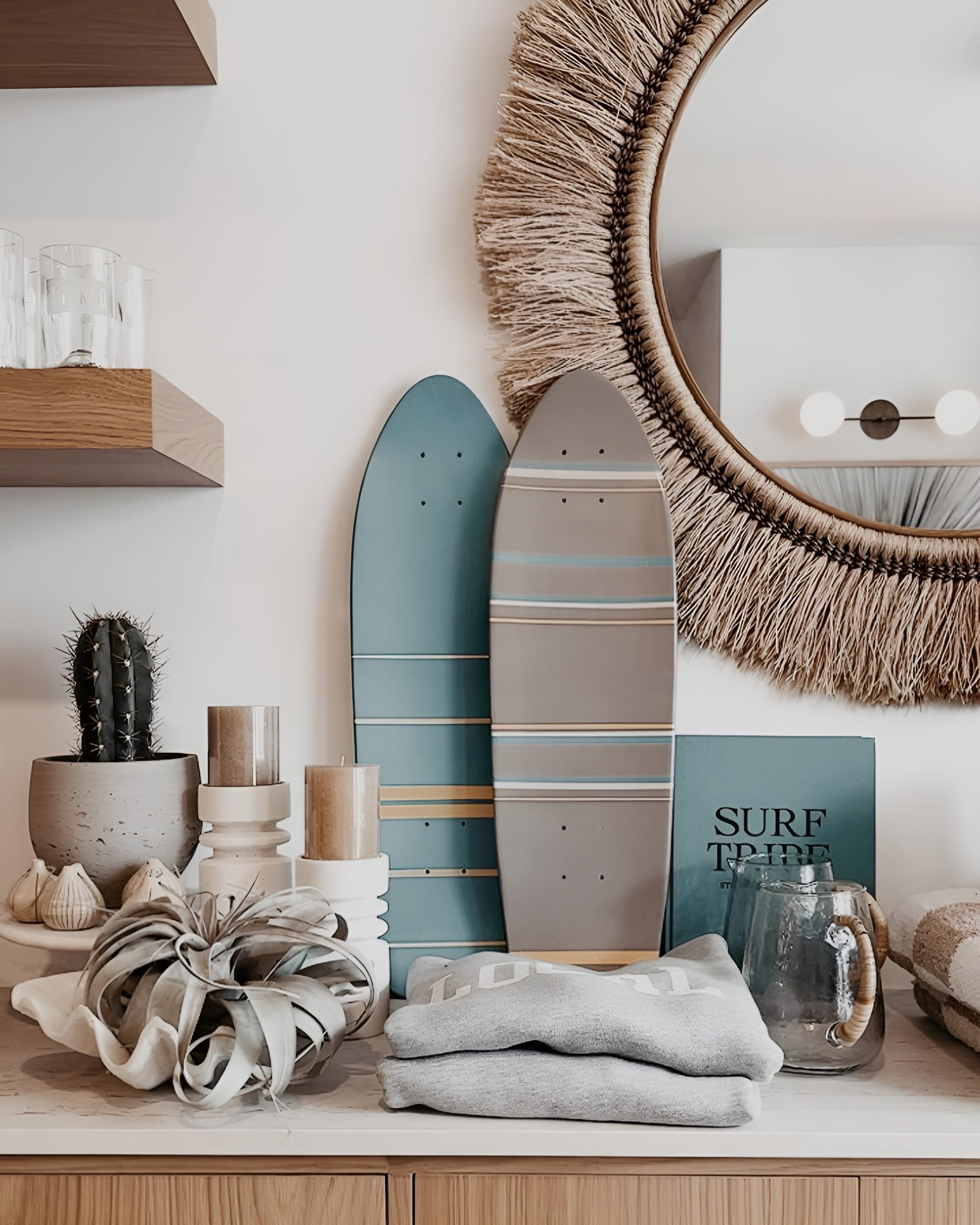 Two decorative skateboards are styled on a shelf alongside candles, a cactus, and cozy home accents, creating a laid-back and stylish bedroom decoration.