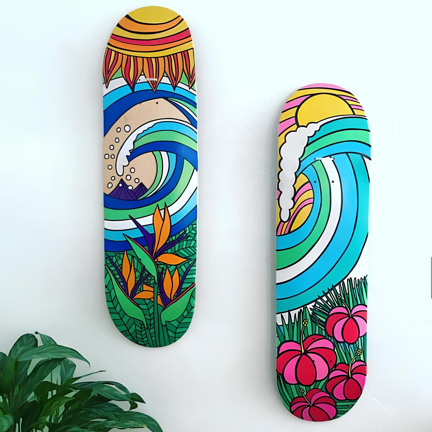 Two colorful skateboards with tropical and wave-themed artwork are mounted on a white wall as vibrant decoration for a girl's bedroom.