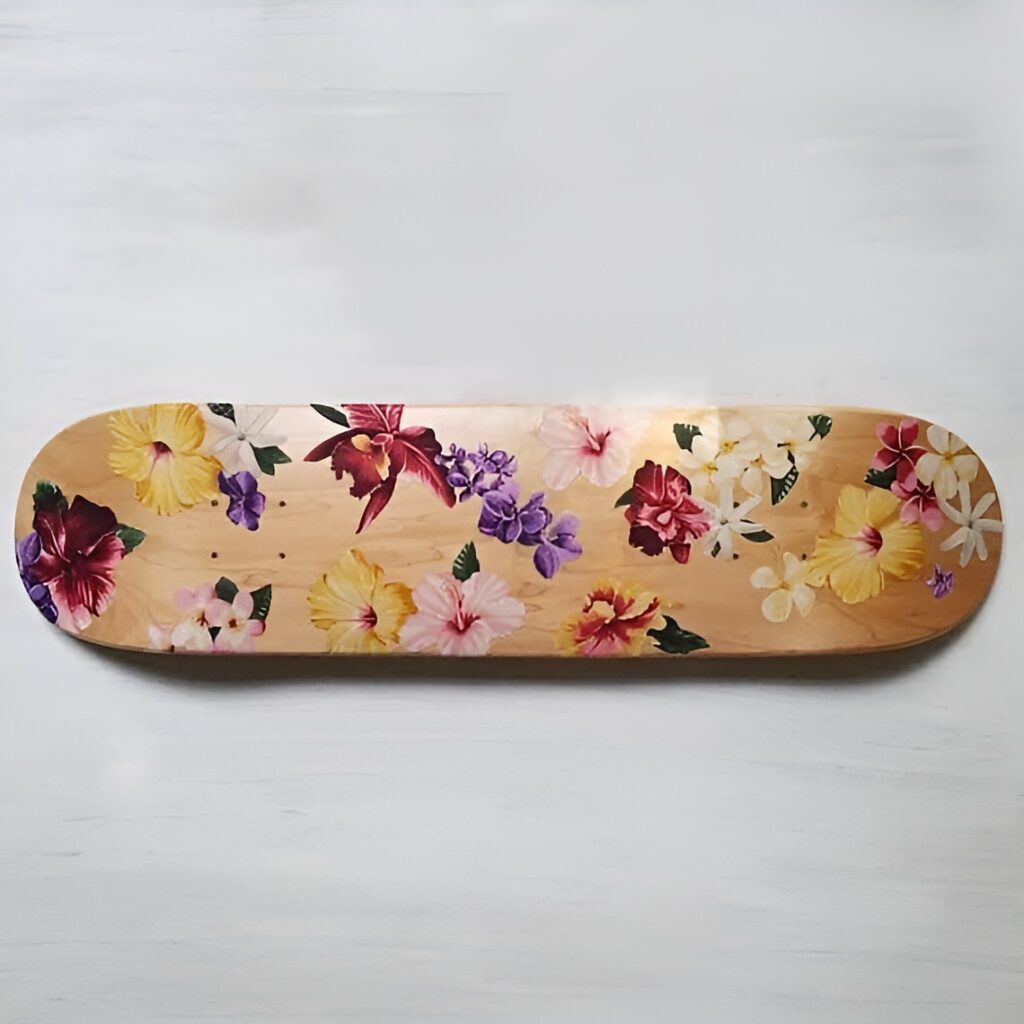 A wooden skateboard deck with delicate flower designs in pink and orange tones is displayed as skateboard wall art in a girls bedroom, blending botanical charm with creative decor.