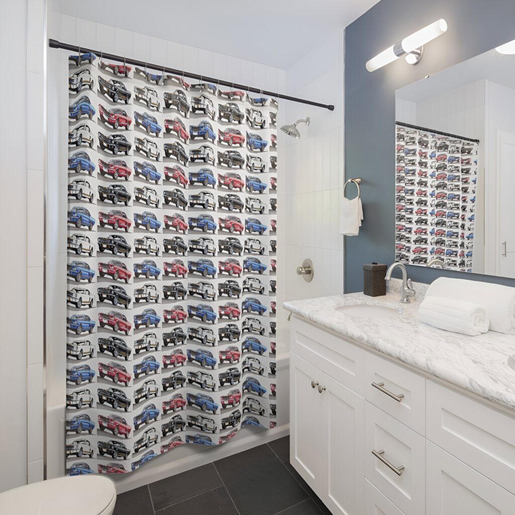 A modern bathroom with a car-themed shower curtain, marble countertops, and sleek fixtures, offering unique bathroom design ideas for a kid's space.