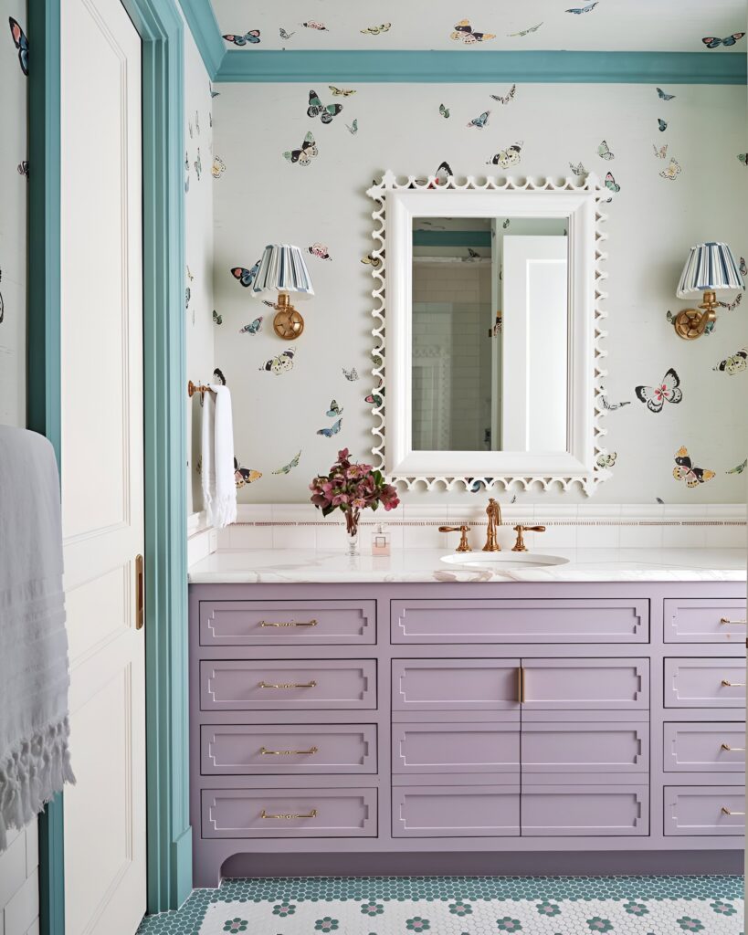 Elegant girls' bathroom design featuring a lavender vanity with gold hardware, butterfly wallpaper, and teal trim accents for a playful yet sophisticated look.