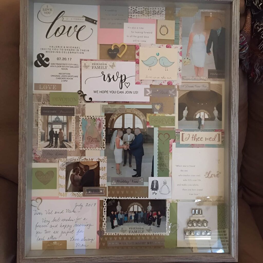 Scrapbook frame collage featuring wedding photos, decorative paper cutouts, and mementos creatively arranged in a shadow box style display.